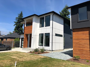 Modern two-storey home with white panel cladding and warm wood accents
